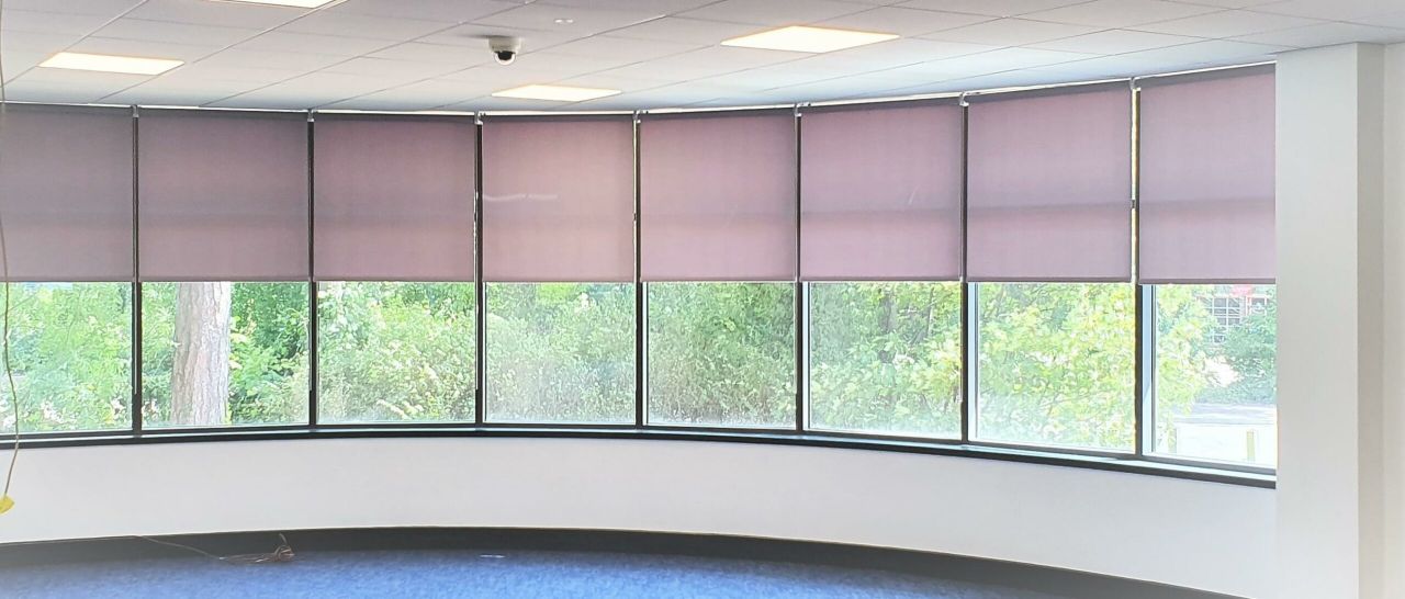 A row of roller blinds fitted across a long run of windows at Bletchley Campus